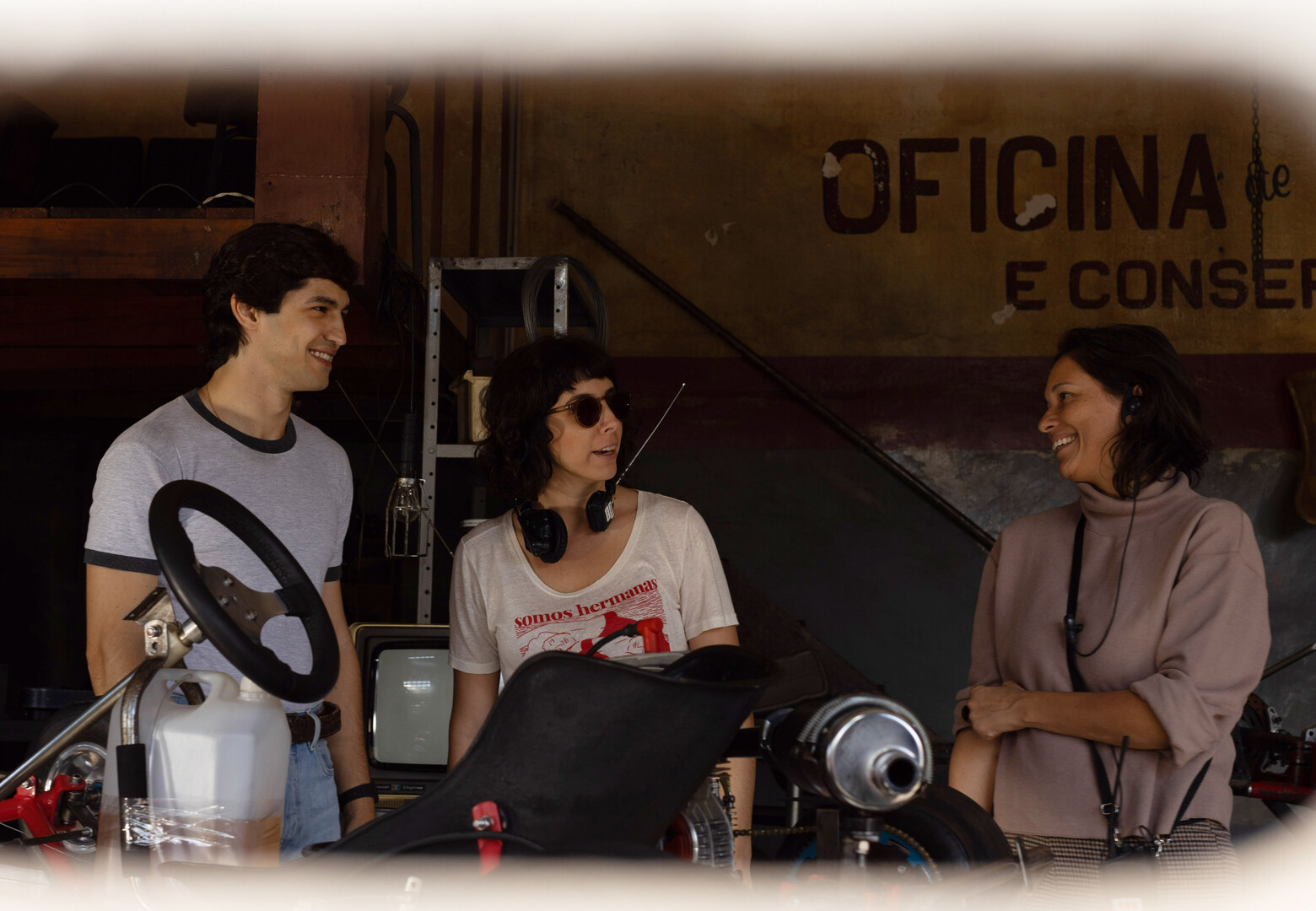 Gabriel Leone and two female crew members with a go-cart in the foreground